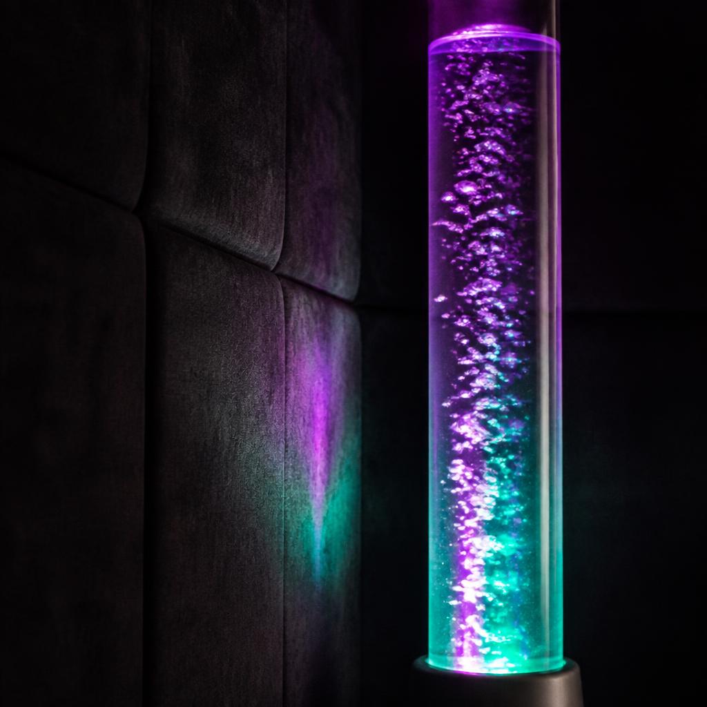 Close-up of a sensory bubble tube glowing purple and teal against the black acoustic felt lining of a Peace POD